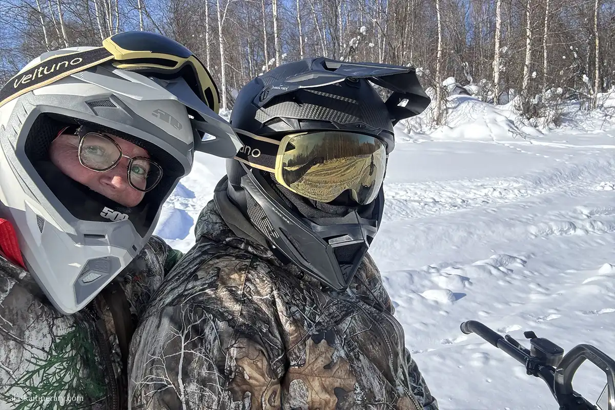 Agnes Stabinska, the author, with her partner Chris during snowmobile tour in winter landscape.