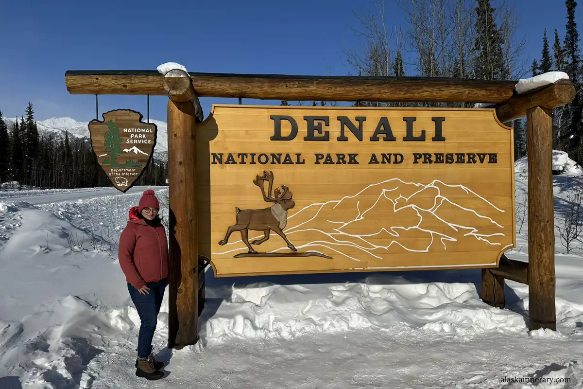 Agnes Stabinska, the author, next to sign Denali National Park and Preserve in winter scenery.