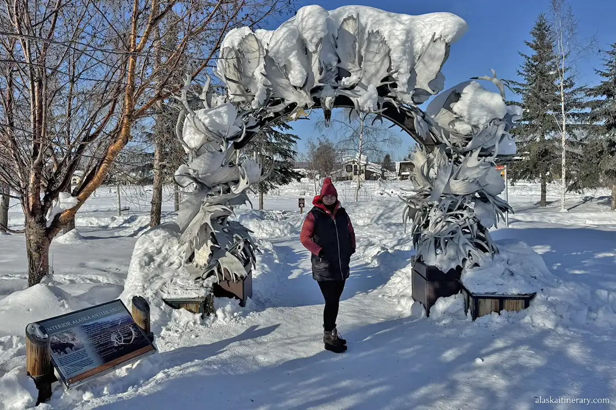 Agnes Stabinska, the author, next to Antler Arch covered by snow in downtown Fairbanks.